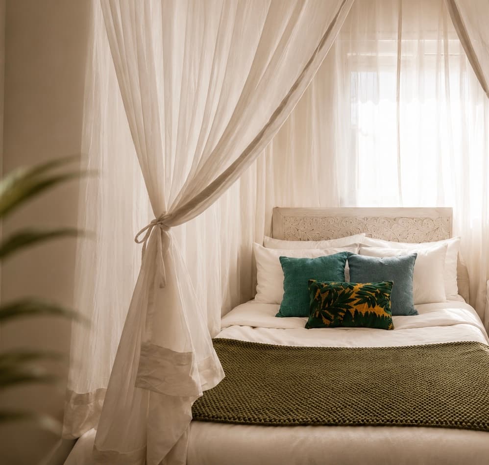 Serene bedroom framed by sheer canopy curtains