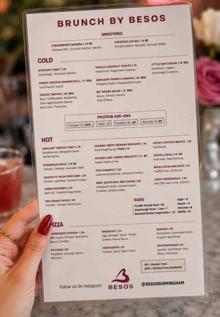 BESOS brunch menu held in hand